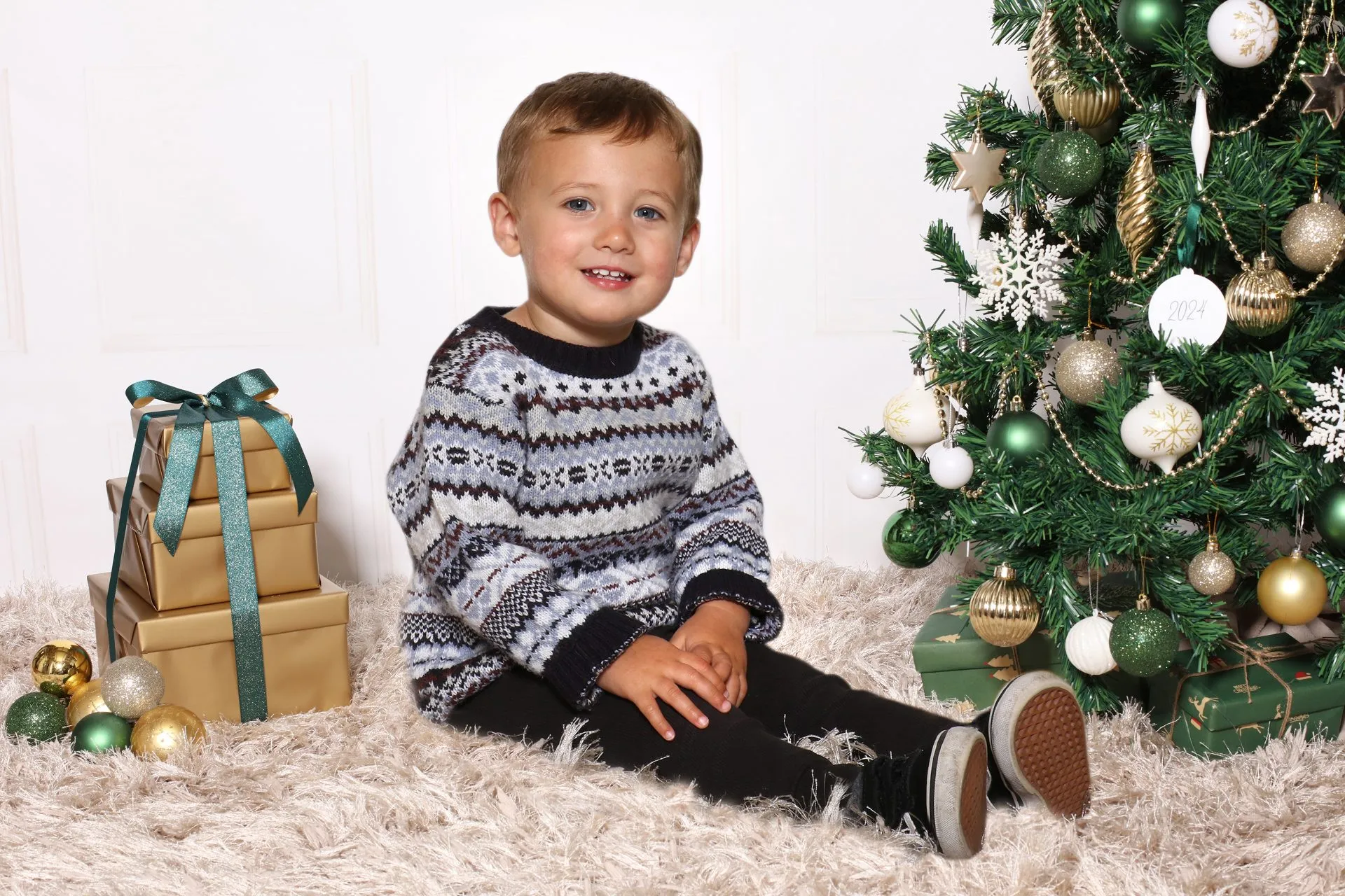 A nursery child by the Christmas tree
